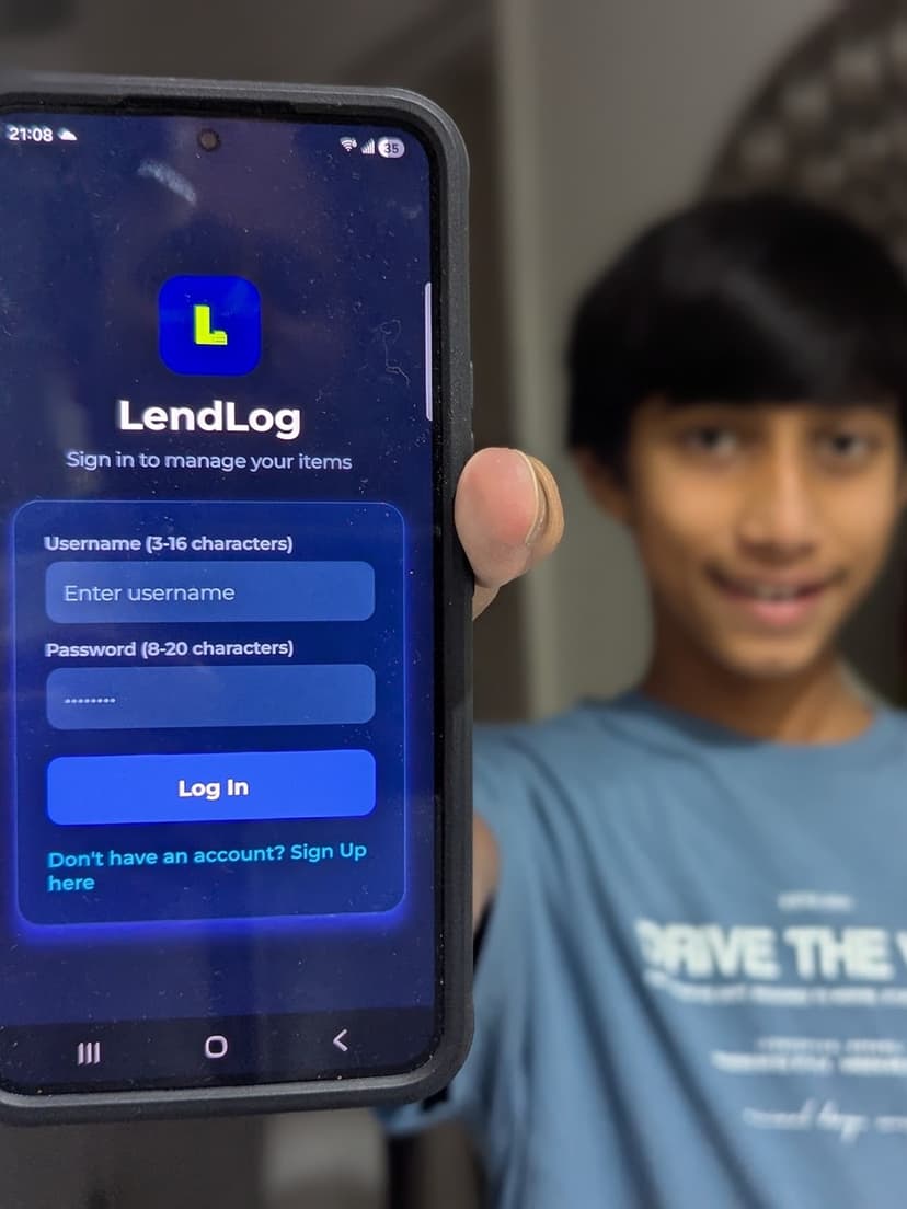 A PsyntaxLabs Academy student holding a phone showing the app he built